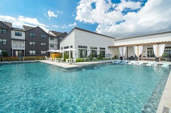 Resort-inspired pool with water features and lounge seating
